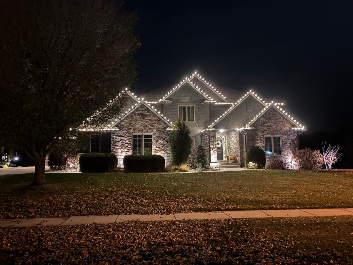 Warm white C9 bulbs following every peak and eave across the front of a large two story home