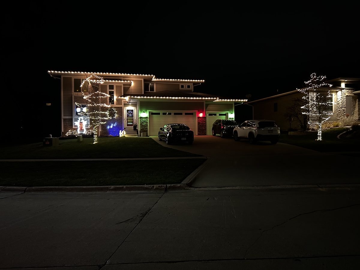 C9 bulbs cut to fit the eaves, garage line and front gable of a suburban home at dusk
